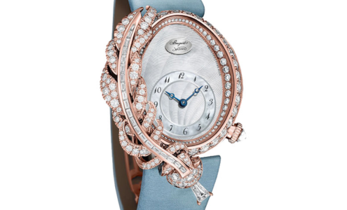 A distinctive watch from Breguet, featuring diamond accents and an asymmetrical case with a large feather-like ornament, available at Hing Wa Lee Jewelers.
