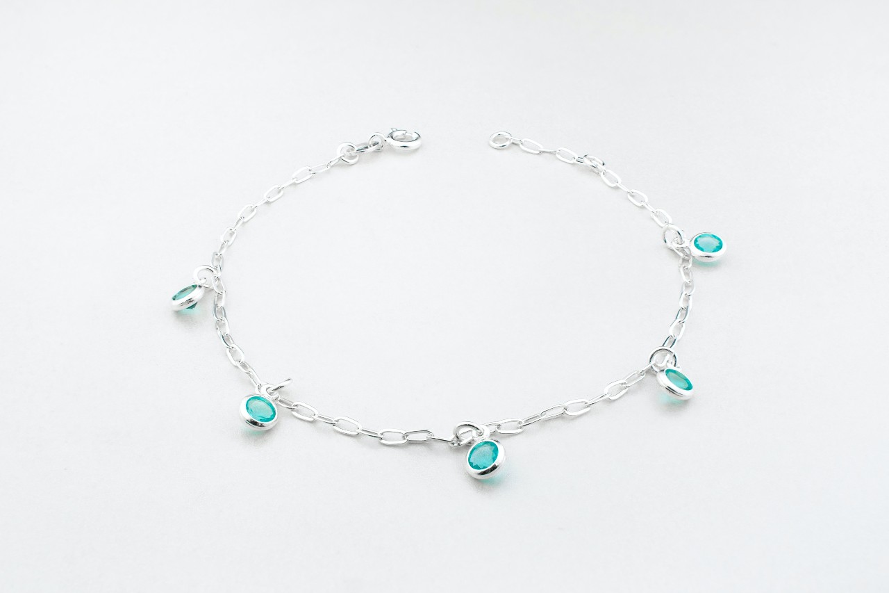 a silver chain station bracelet with turquoise, bezel-set stones