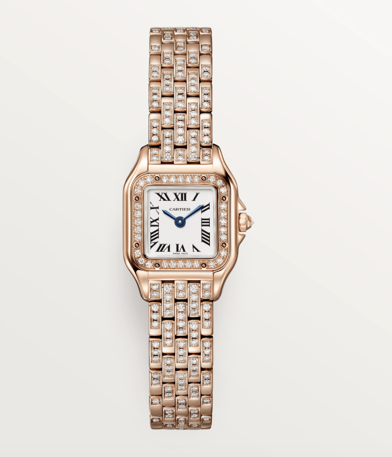 A rose gold diamond encrusted Cartier wristwatch with a white dial and roman numerals.