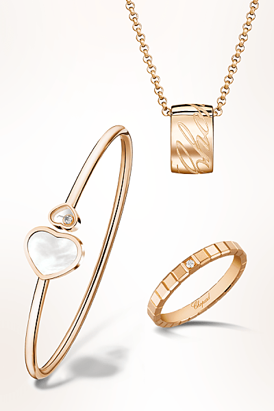 Chopard&rsquo;s exquisite jewelry pieces featuring a rose-gold bracelet with a heart motif, a ring with a small diamond, and a necklace with a textured pendant.