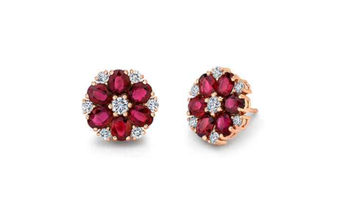 An elegant pair of diamond stud earrings accented by rubies and rose gold, available at Hing Wa Lee Jewelers.
