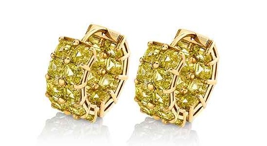 a pair of yellow gold huggies earrings inlaid with round cut yellow diamonds