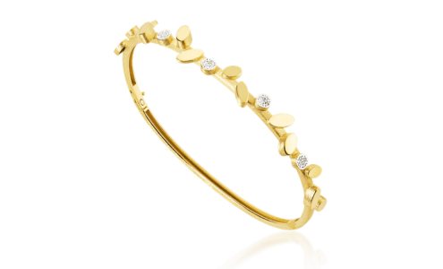 A whimsical yellow gold bracelet with diamond accents from Luisa Rosas, available at Hing Wa Lee Jewelers.