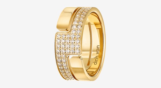 a yellow gold cuff bracelet with a geometric silhouette and is inlaid with diamonds
