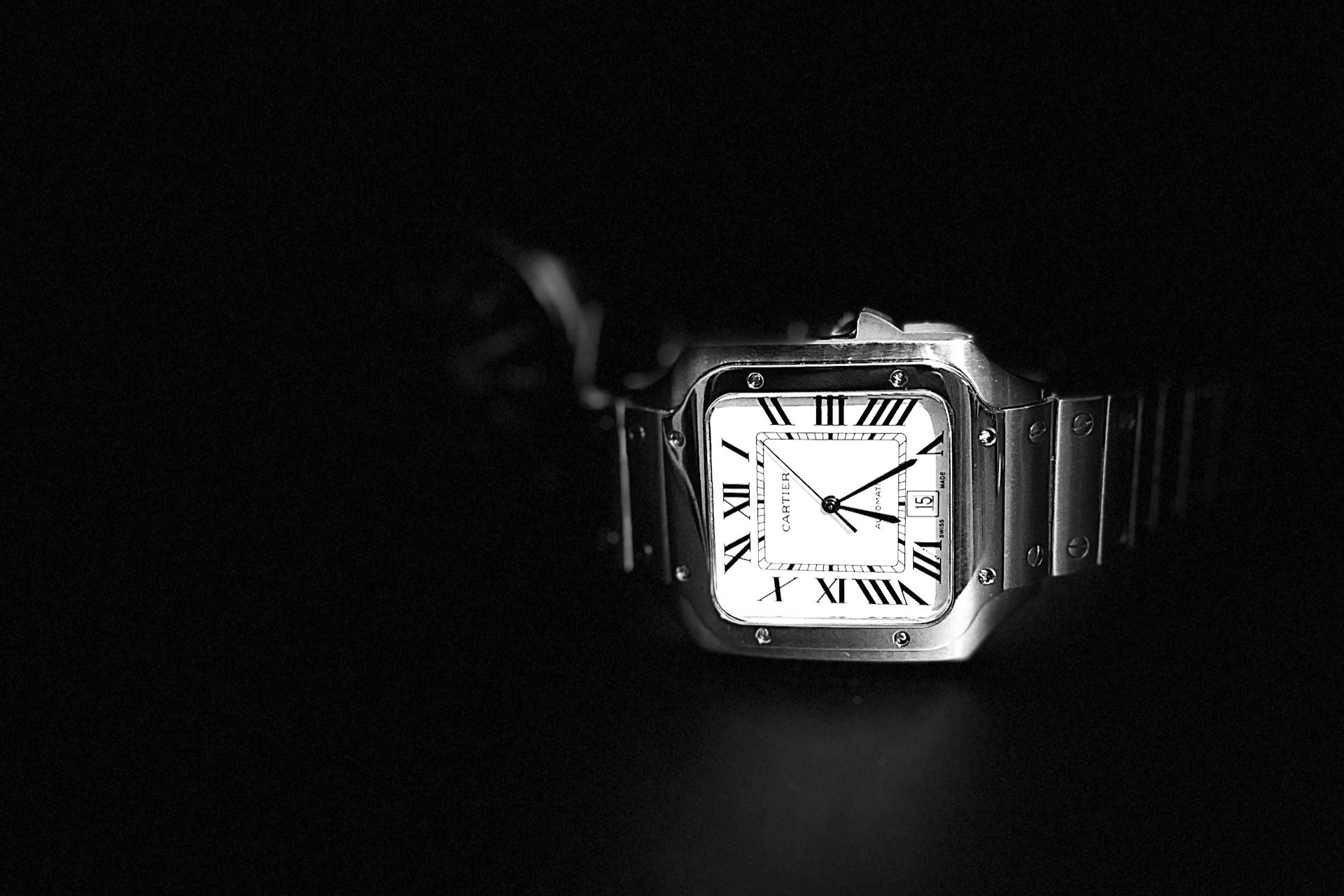 a Cartier watch on a black background
