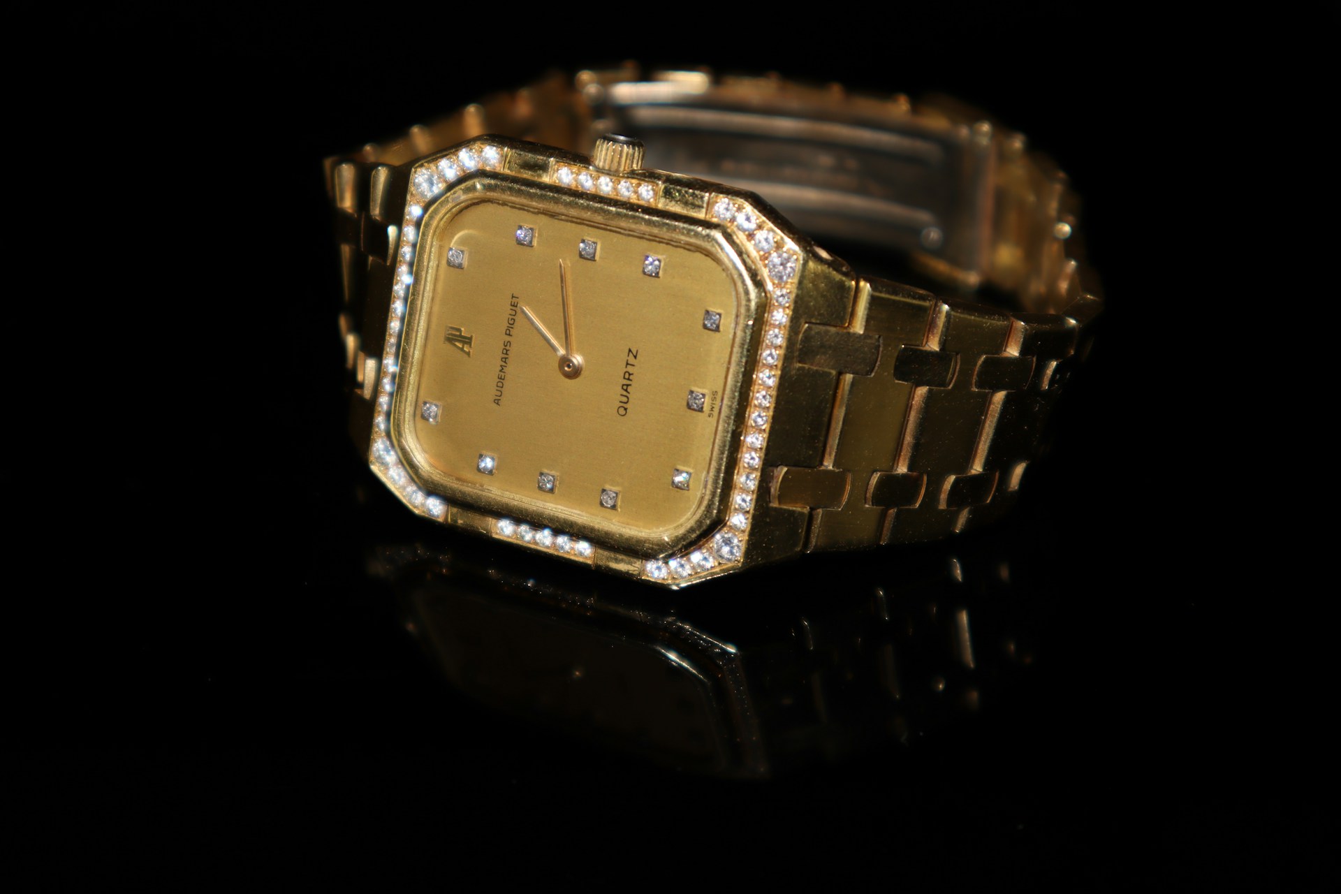 a yellow gold Audemars Piaget automatic watch with diamond accents
