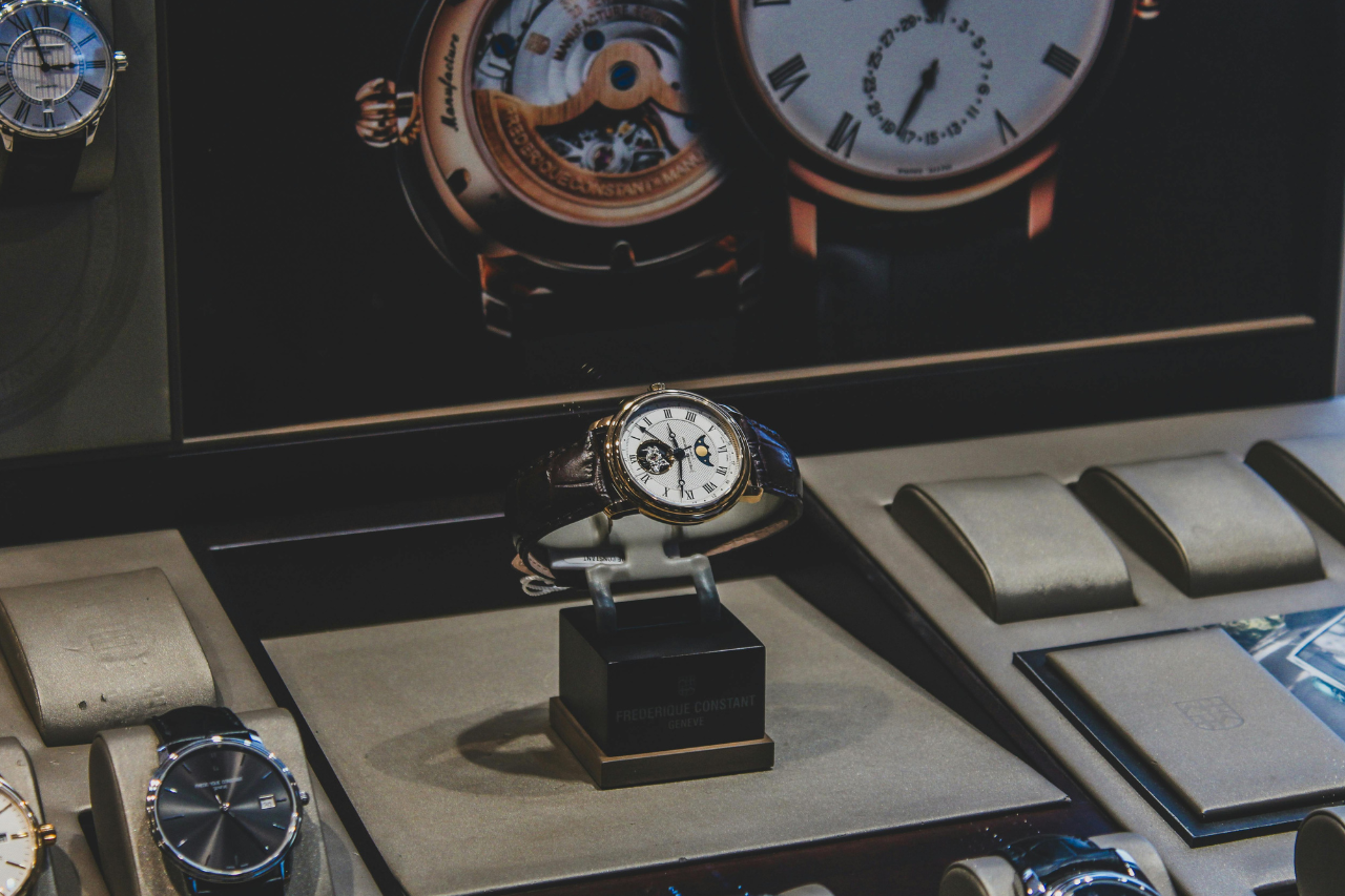 A view of a luxurious designer watch display, with emphasis on an elegant watch with distinctive complications.