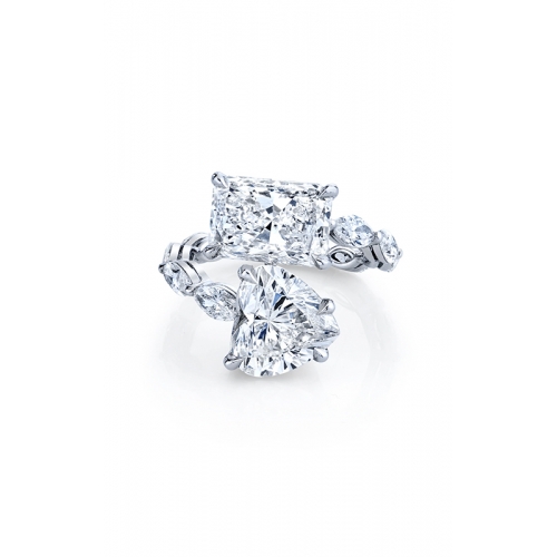 A two-stone white gold ring featuring a radiant-cut and a heart-shaped diamond, accented with smaller diamonds along the band.