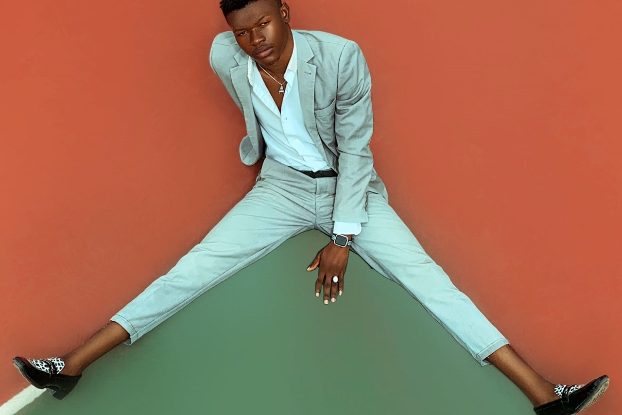 a man in a light blue suit wearing a luxurious watch