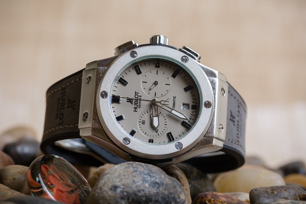 a Hublot watch resting on some rocks