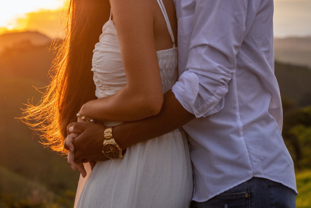 Man and woman wearing jewelry and embracing in the sunset Man and woman wearing jewelry and embracing in the sunset