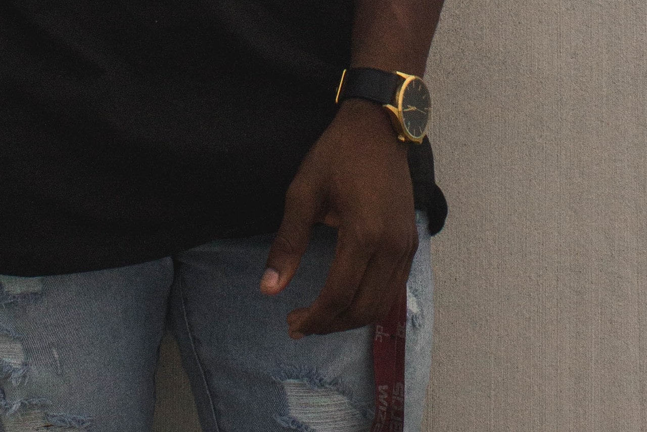 A man’s hand wearing a wristwatch A man’s hand wearing a wristwatch