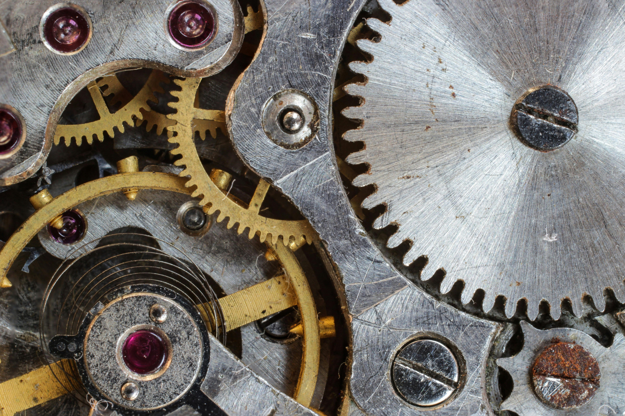 An extreme close-up of the mechanical movement inside of a well-used luxury watch.