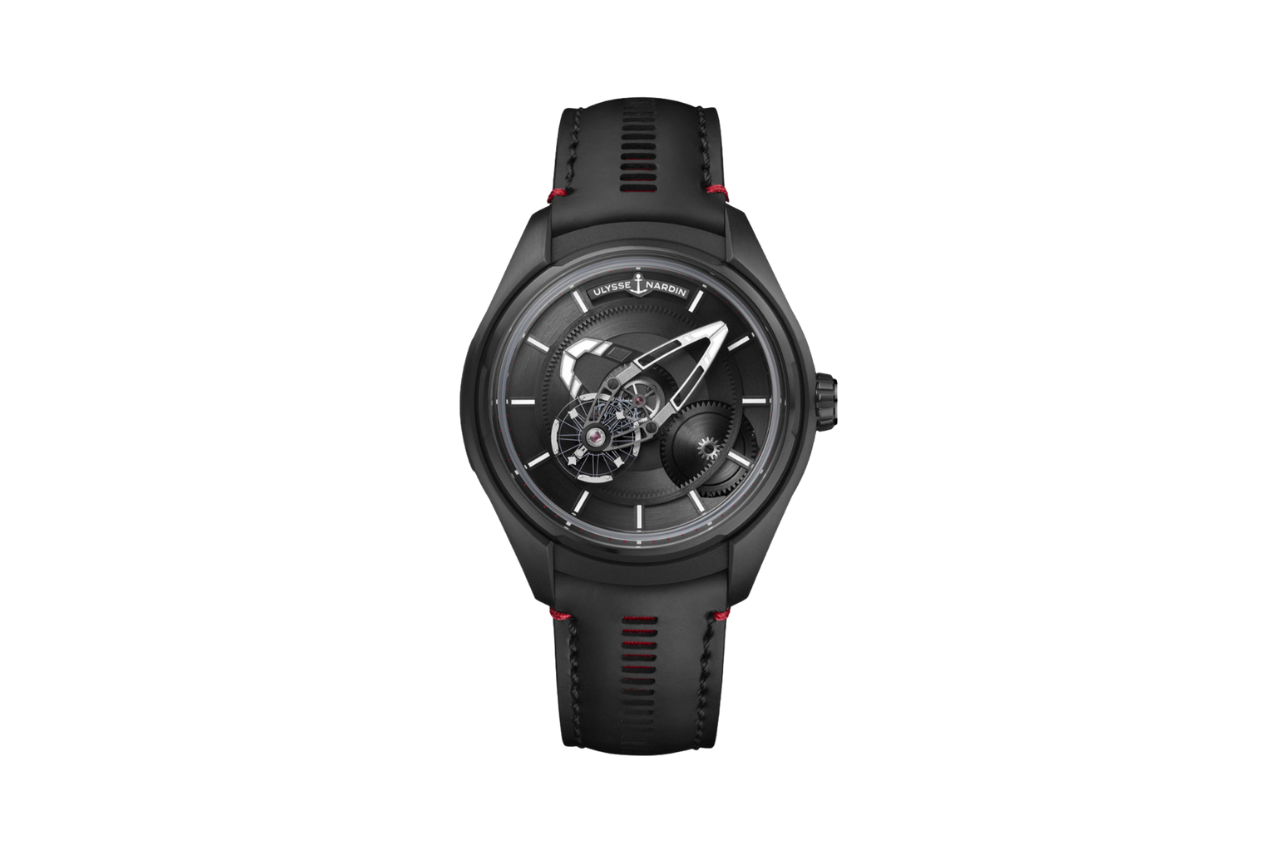 A sleek all black watch with a unique watchface design and accents of red on the band.