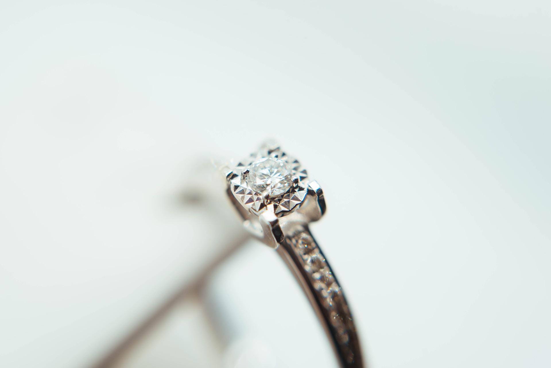 a white gold diamond engagement ring with channel set side stones