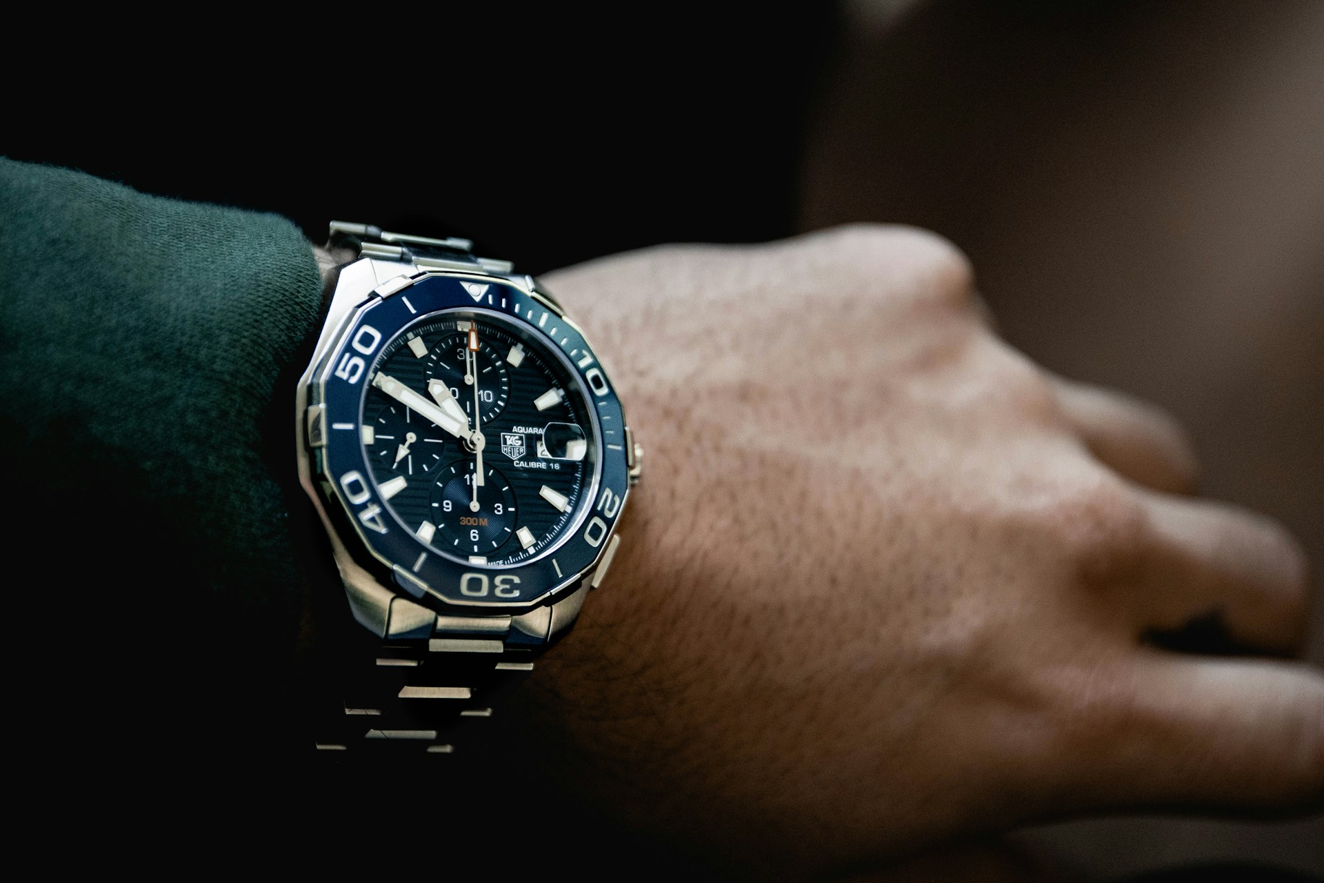 a man’s wrist wearing a TAG Heuer watch