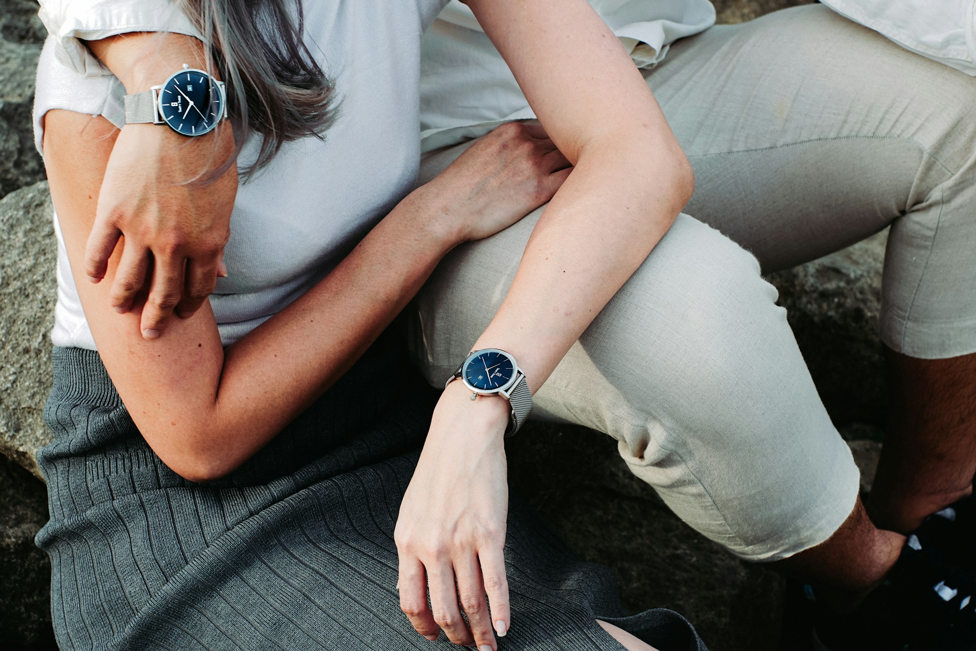 a couple embracing and wearing luxury watches