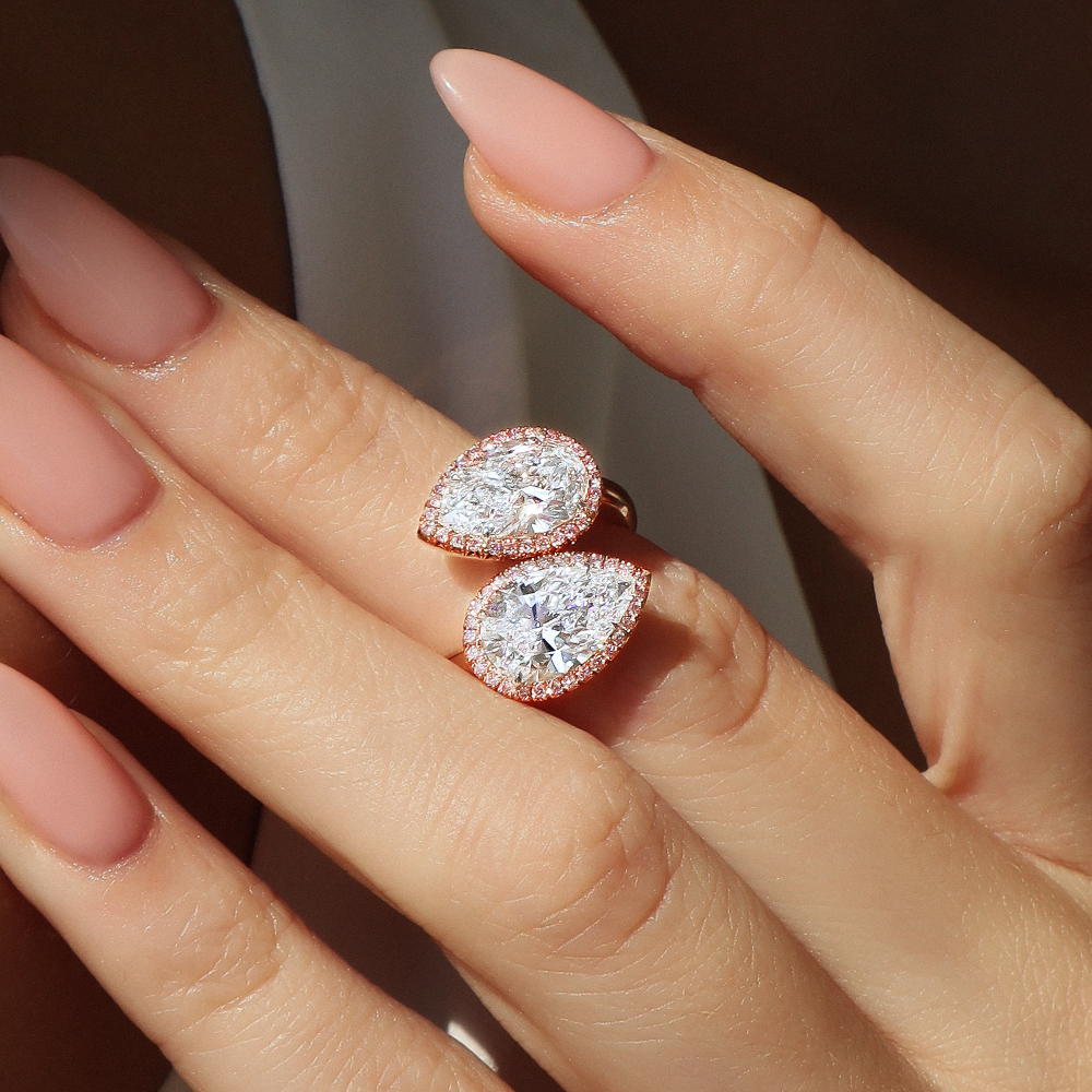 close up of a woman wearing a cream sweater and a solitaire radiant cut engagement ring